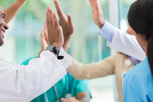 Doctors giving each other high fives